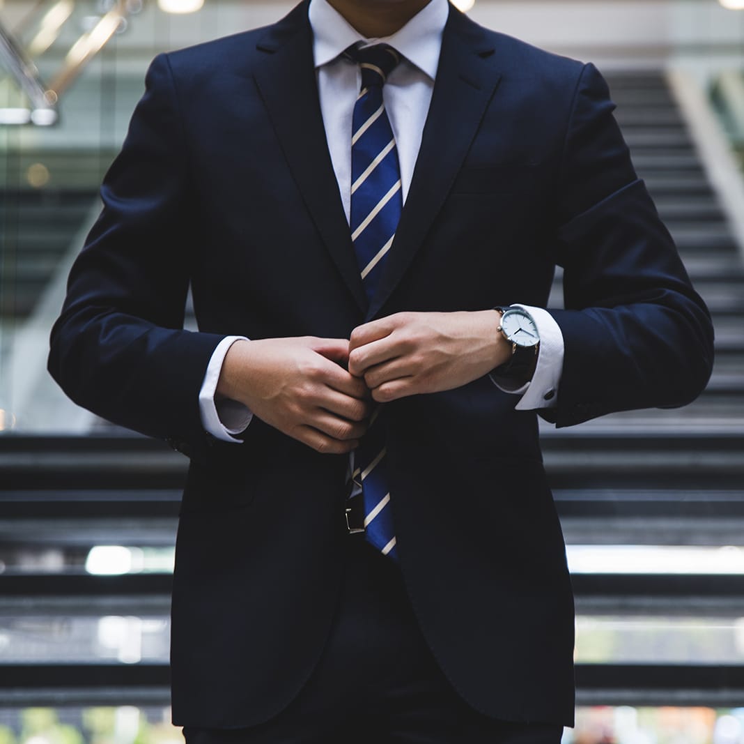 a man in a suit and tie standing in a hallway