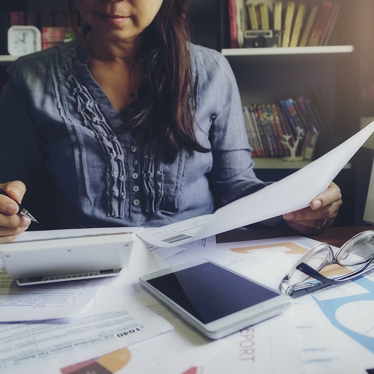 a woman is looking at a piece of paper