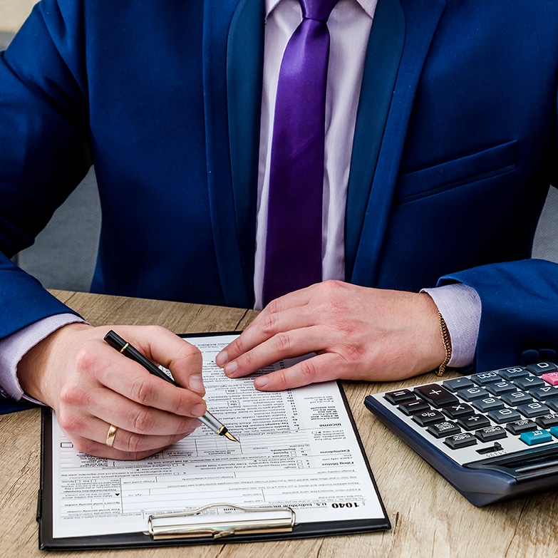 a man in a suit writing on a piece of paper