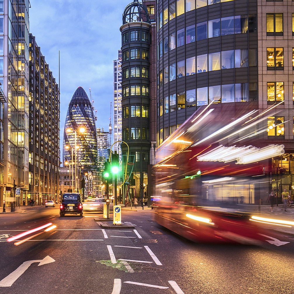 a city street with cars and buses on it