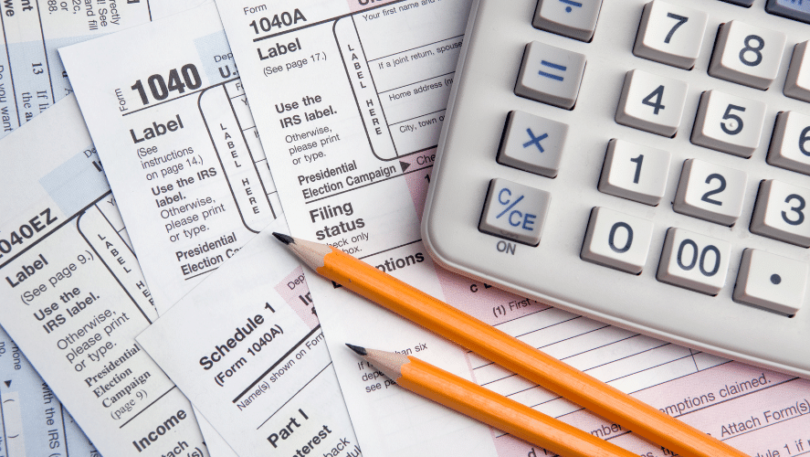 a table with papers, pencils, and a calculator