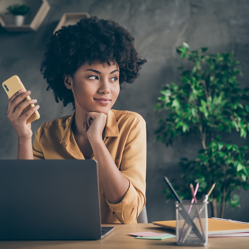 a woman sitting at a table with a laptop