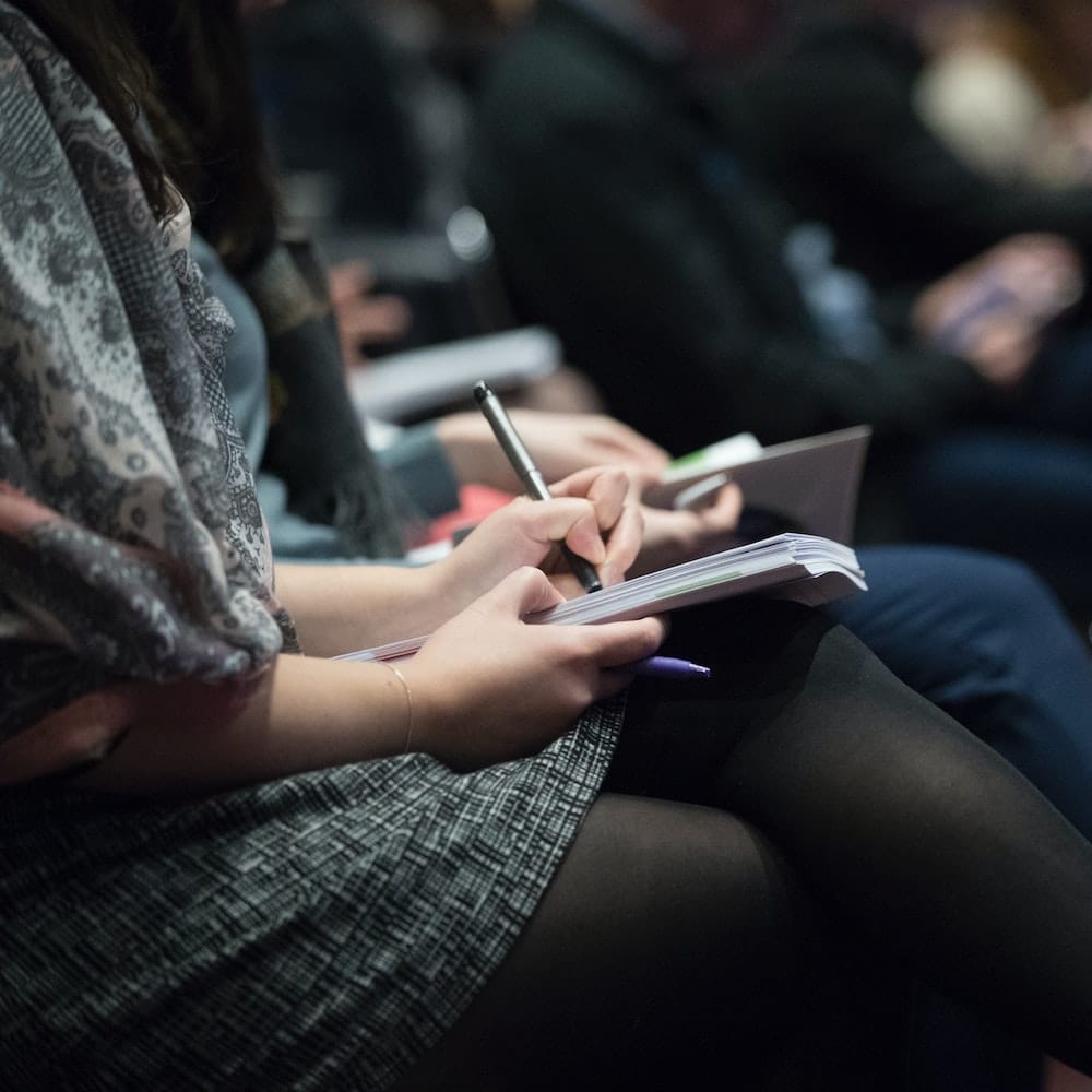 a woman writing in a notebook