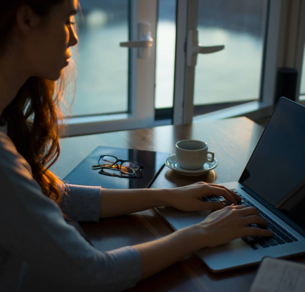 a woman using a laptop computer on a table