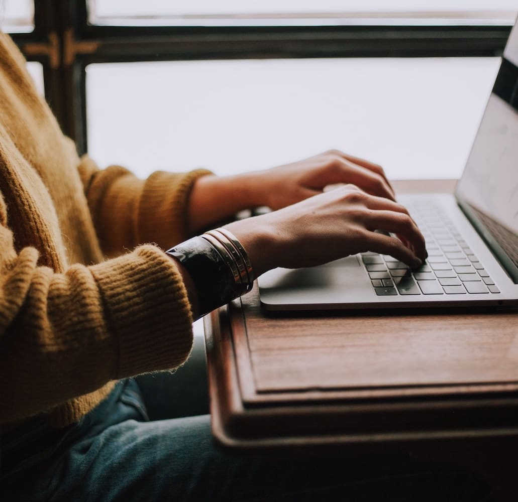 a person using a laptop computer on a counter