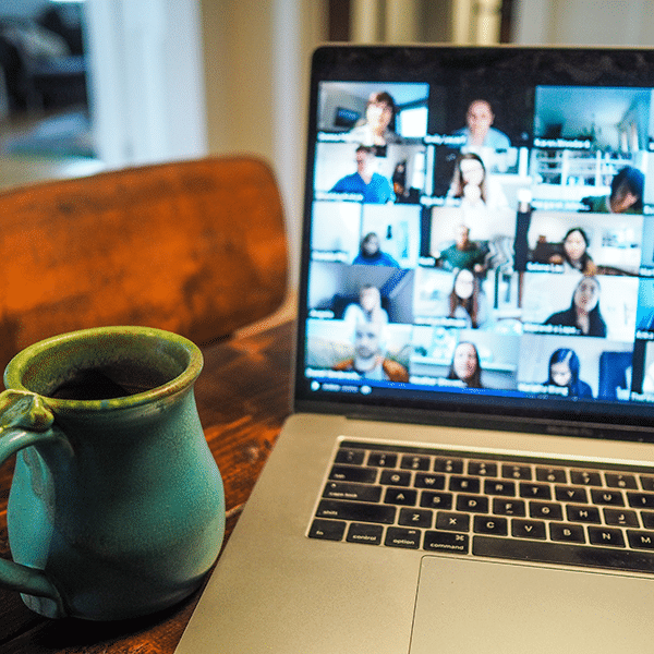 a laptop computer sitting on a table next to a coffee cup