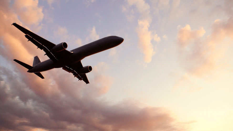 a large jetliner flying through a cloudy sky