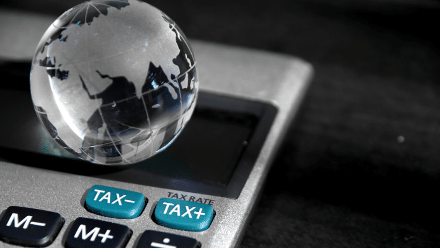 a small glass globe on top of a calculator