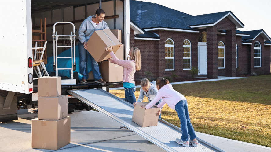 a family moving boxes from a house