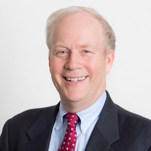 a man in a suit and tie smiling