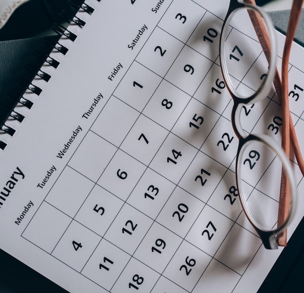 a calander with glasses on top of it