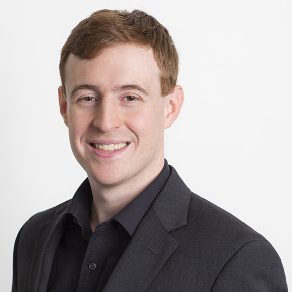 a man in a suit and tie smiling