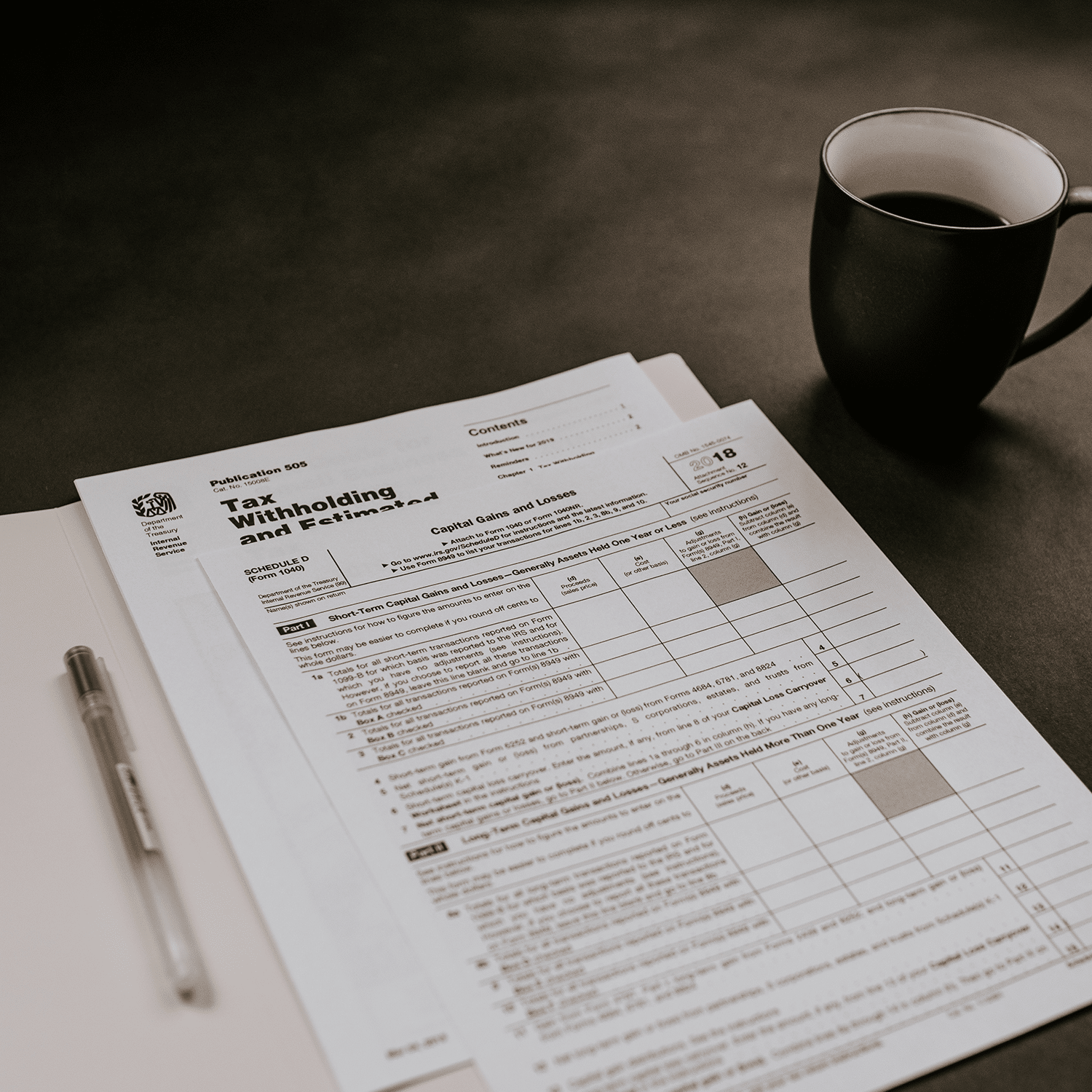 a table with tax papers and a coffee mug