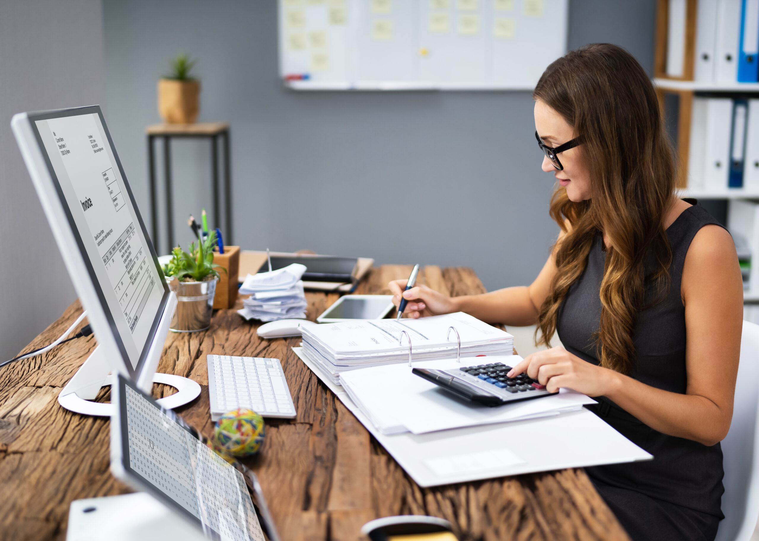 a woman sitting at a table with a laptop