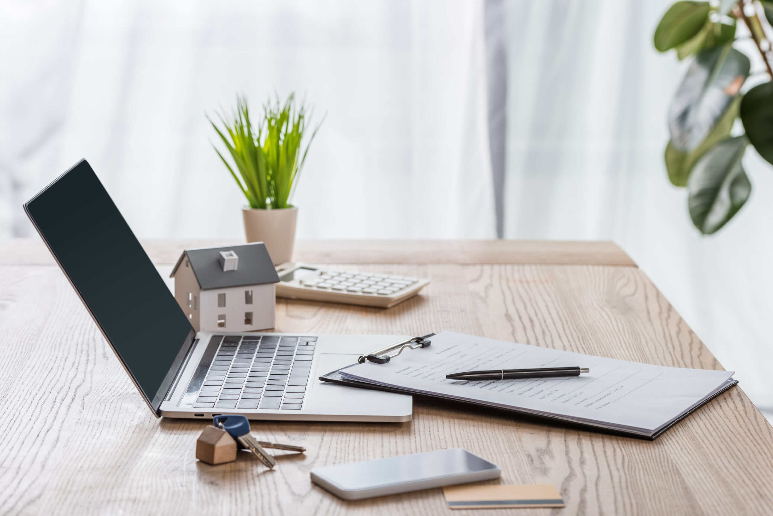 a desk with a laptop and various desk stationary