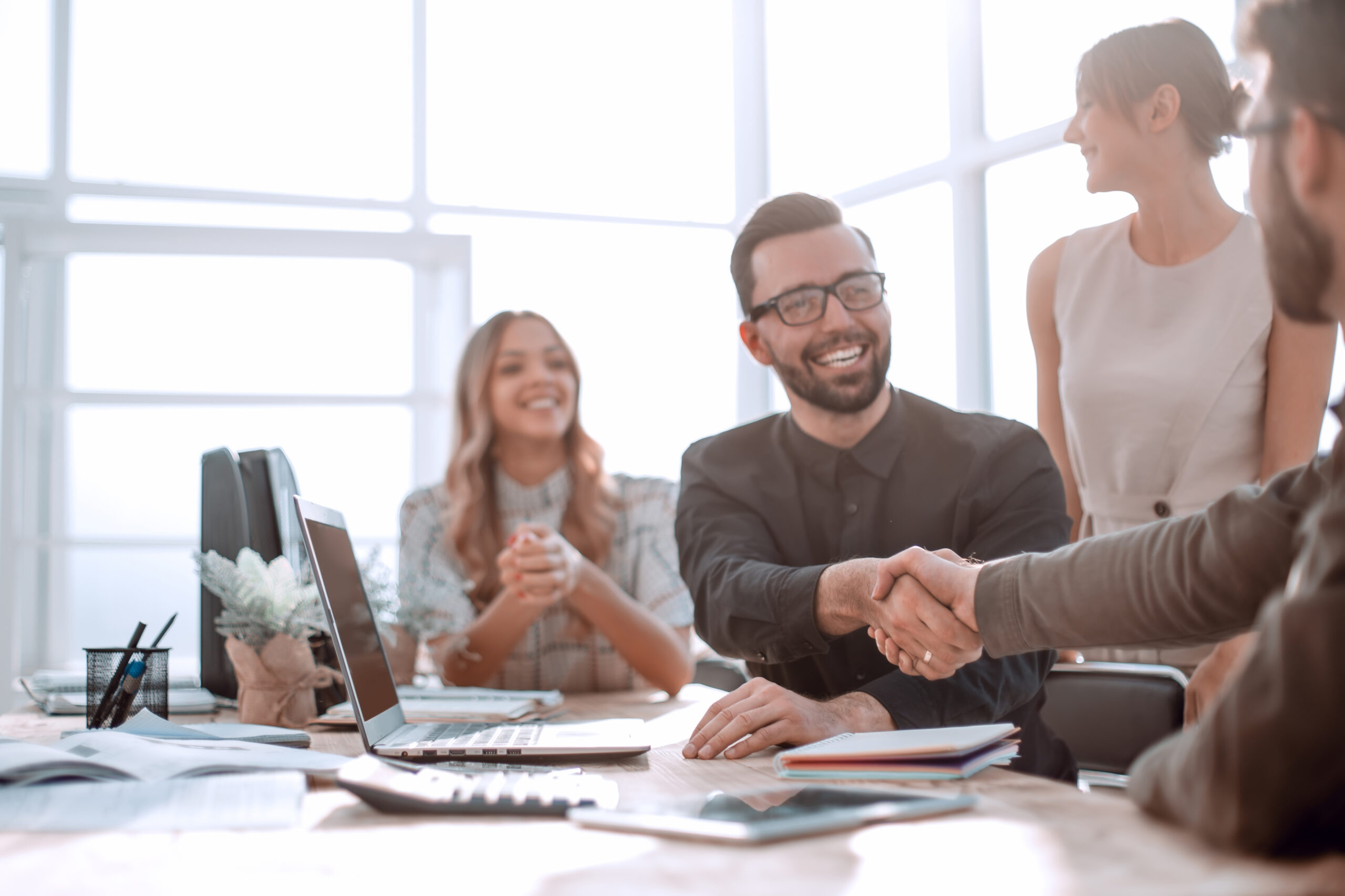 four office workers sitting at a table