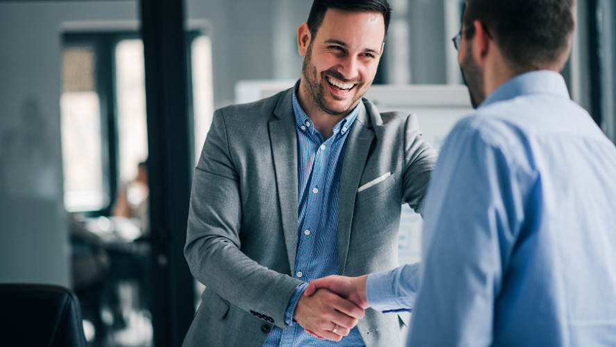 two men in suits shaking hands